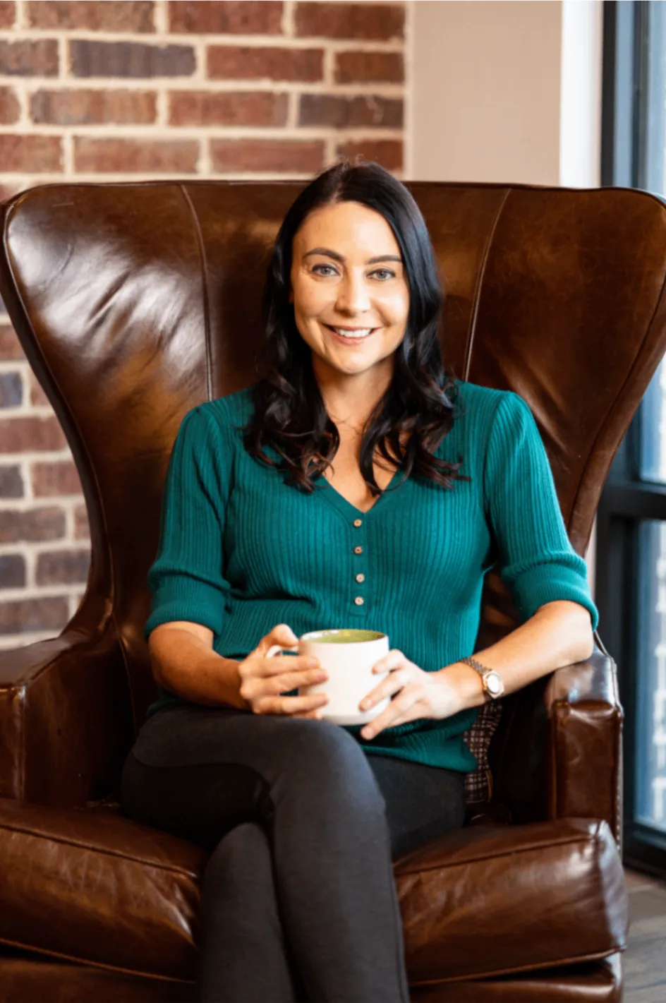 Professional coach seated in a warm, welcoming home setting
